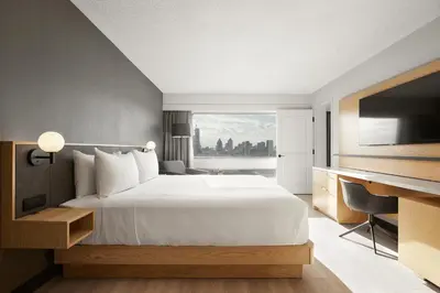 a bedroom with a large white bed and a window at Hyatt Place Montreal - Downtown in Montréal