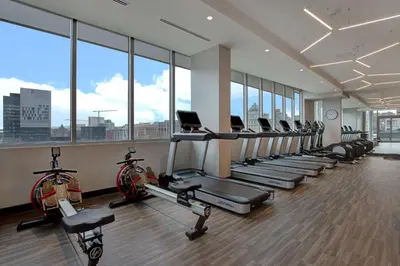 a gym with a row of treadmills and bikes at Homewood Suites By Hilton Montreal Downtown in Montréal