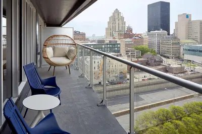 a balcony with chairs and a view of a city at Homewood Suites By Hilton Montreal Downtown in Montréal