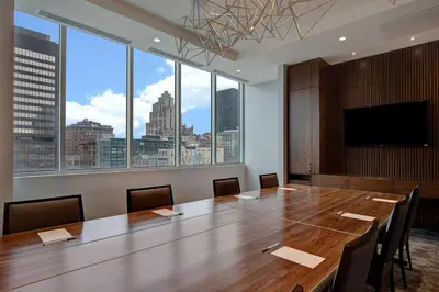 a conference room with a large wooden table and a large window at Homewood Suites By Hilton Montreal Downtown in Montréal