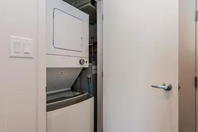an open door to a kitchen with a microwave at Huge New Flat well Located closed on St-Denis Street by Den Stays in Montréal