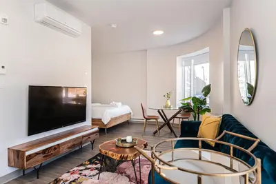 a living room with a tv and a couch at Huge New Flat well Located closed on St-Denis Street by Den Stays in Montréal