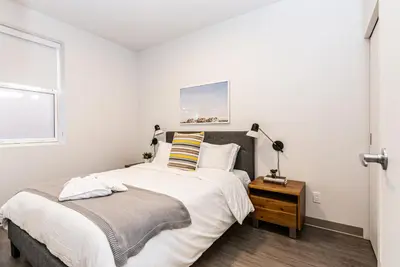 a bedroom with a large bed and a window at New Urban and Well Located 1 Bedroom Apartment by Den Stays in Montréal