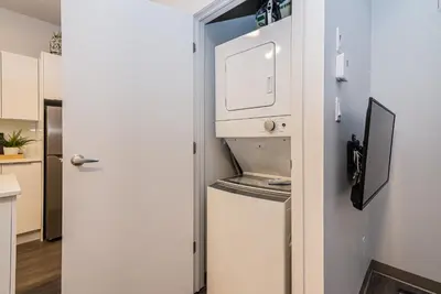 a kitchen with a refrigerator and a microwave at New Urban and Well Located 1 Bedroom Apartment by Den Stays in Montréal