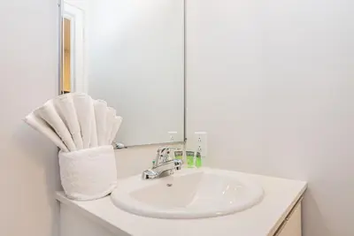 a bathroom with a sink and a mirror at New Urban and Well Located 1 Bedroom Apartment by Den Stays in Montréal