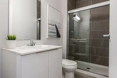 a bathroom with a toilet and a sink and a shower at Modern and New Studio in the Heart of the City by Den Stays in Montréal