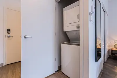 a kitchen with a refrigerator and a microwave at Modern and New Studio in the Heart of the City by Den Stays in Montréal