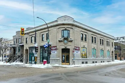 a building on the corner of a street with a traffic light at Modern and New Studio in the Heart of the City by Den Stays in Montréal