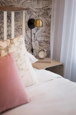 a bedroom with a bed and a table with an alarm clock at Perfect Business Trip Studio with Full Amenities by Den Stays in Montréal