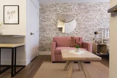 a living room with a pink couch and a table at Perfect Business Trip Studio with Full Amenities by Den Stays in Montréal