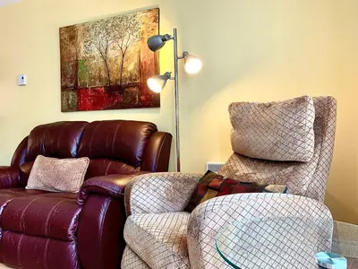 a living room with a couch and a chair at Le Paréo de Magog-Mont Orford in Magog-Orford