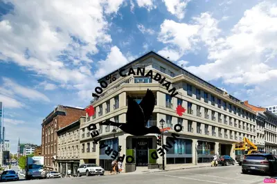 a large building with a sign on the top of it at Hygie Boutique Hotel in Montréal