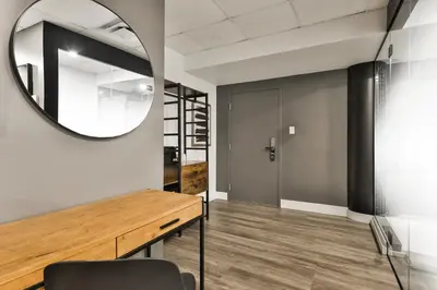 a room with a mirror and a table with a chair at Hygie Boutique Hotel in Montréal