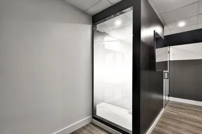 a glass door in a room with a white wall at Hygie Boutique Hotel in Montréal