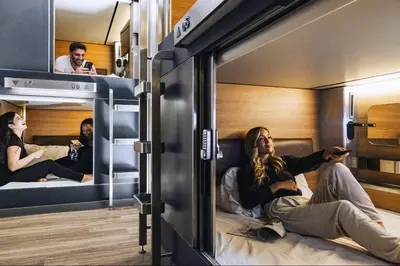 a group of people sitting in bunk beds at Hygie Boutique Hotel in Montréal