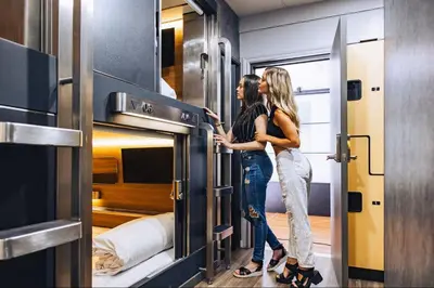 two women standing in front of a room at Hygie Boutique Hotel in Montréal