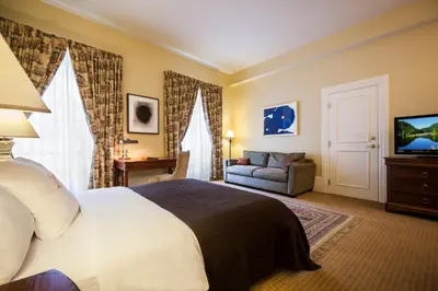 a bedroom with a bed and a couch and a television at LHotel in Montréal