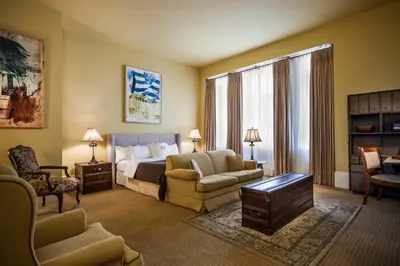 a hotel room with a bed and a couch and chairs at LHotel in Montréal