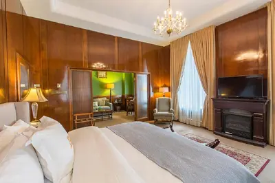 a bedroom with a large bed and a fireplace at LHotel in Montréal