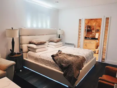 a bedroom with a large bed with pillows on it at Hotel Kutuma in Montréal
