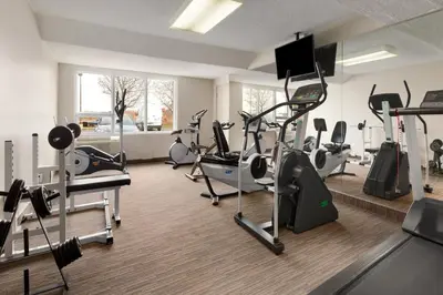 a gym with treadmills and cardio equipment in a room at Days Inn by Wyndham Montreal Airport Conference Centre in Dorval