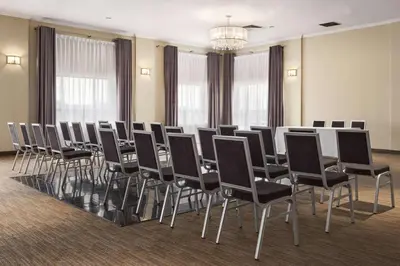 a conference room with a table and chairs at Days Inn by Wyndham Montreal Airport Conference Centre in Dorval