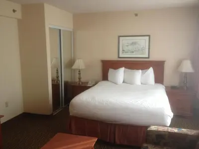 a hotel room with a bed with white sheets and pillows at Hotel Chrome Montreal Centre-Ville in Montréal