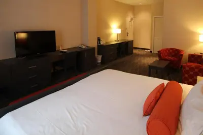 a hotel room with a bed and a flat screen tv at Hotel Chrome Montreal Centre-Ville in Montréal