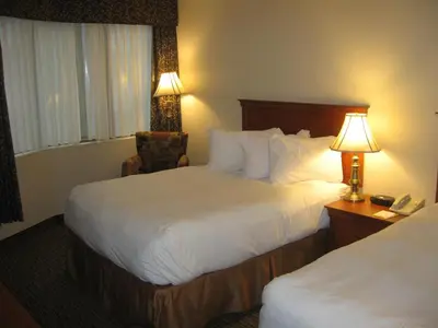 a hotel room with two beds and a desk with a phone at Hotel Chrome Montreal Centre-Ville in Montréal