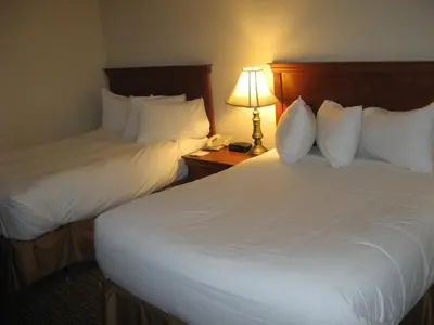 a hotel room with two beds and a lamp at Hotel Chrome Montreal Centre-Ville in Montréal