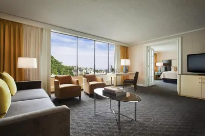 a hotel room with a couch and a room with a view at Omni Mont-Royal Hotel in Montréal