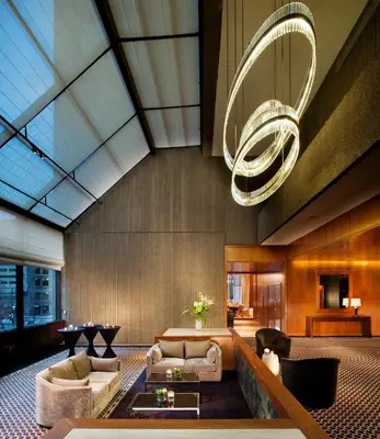 a lobby with couches and a chandelier at Omni Mont-Royal Hotel in Montréal
