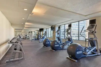 a gym with rows of tread machines in a building at Omni Mont-Royal Hotel in Montréal
