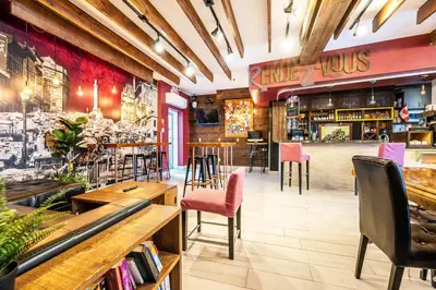 a restaurant with tables and chairs and a bar at Samesun Montreal Hotel & Hostel in Montréal