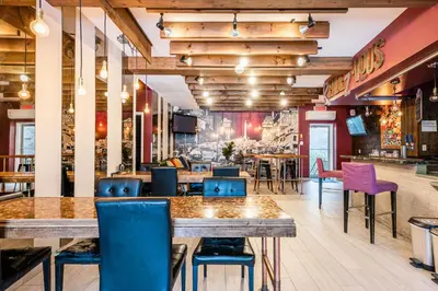 a restaurant with blue and purple chairs and tables at Samesun Montreal Hotel & Hostel in Montréal