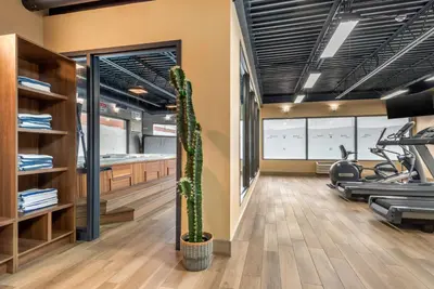 a gym with a cactus and exercise bikes at Quality Hotel Dorval Aeroport in Dorval