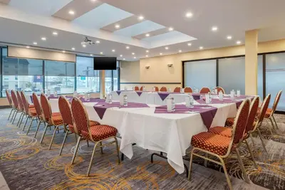 a conference room with a long table and chairs at Quality Hotel Dorval Aeroport in Dorval
