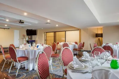 a banquet room with tables and chairs with white tablecloths at Quality Hotel Dorval Aeroport in Dorval