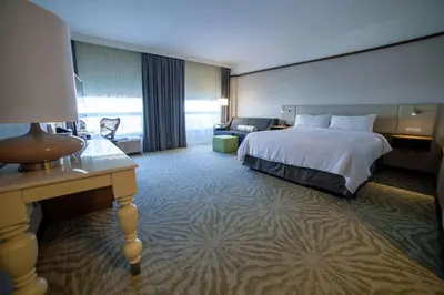 a hotel room with a bed and a desk at Hilton Garden Inn Montreal Airport in Dorval