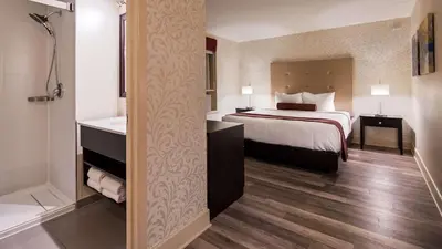 a hotel room with a bed and a bath tub at Hotel Europa, BW Signature Collection in Montréal