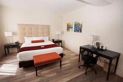 a bedroom with a bed and a desk and a bed sidx sidx sidx at Hotel Europa, BW Signature Collection in Montréal