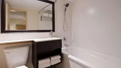 a bathroom with a sink and a mirror and a toilet at Hotel Europa, BW Signature Collection in Montréal