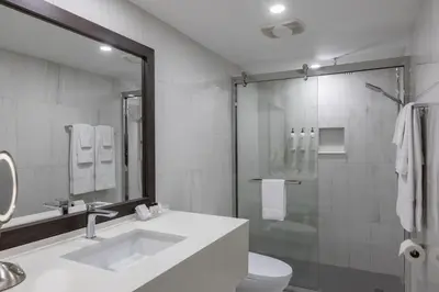 a bathroom with a sink and a toilet and a shower at Le Nouvel Hotel in Montréal