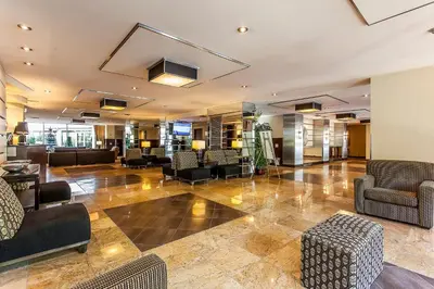 a lobby of a hotel with couches and chairs at Le Nouvel Hotel in Montréal