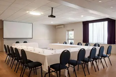 a conference room with a long table and chairs at Ramada Plaza by Wyndham Montreal in Montréal