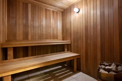 a sauna with a bench in a wooden wall at Ramada Plaza by Wyndham Montreal in Montréal