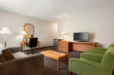 a hotel room with a couch and a tv at Ramada Plaza by Wyndham Montreal in Montréal