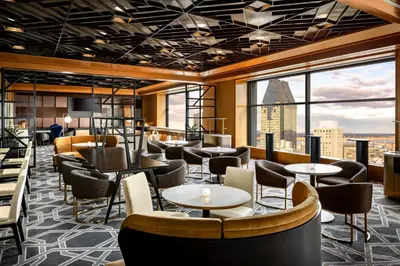 a hotel lobby with tables and chairs and windows at Le Centre Sheraton Montreal Hotel in Montréal