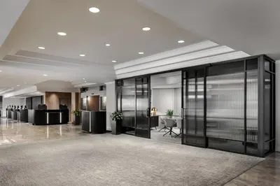 an office lobby with black glass walls and desks at Le Centre Sheraton Montreal Hotel in Montréal