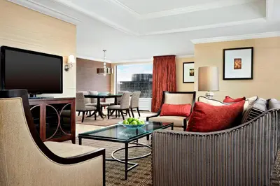 a living room with a couch and a tv at Le Centre Sheraton Montreal Hotel in Montréal